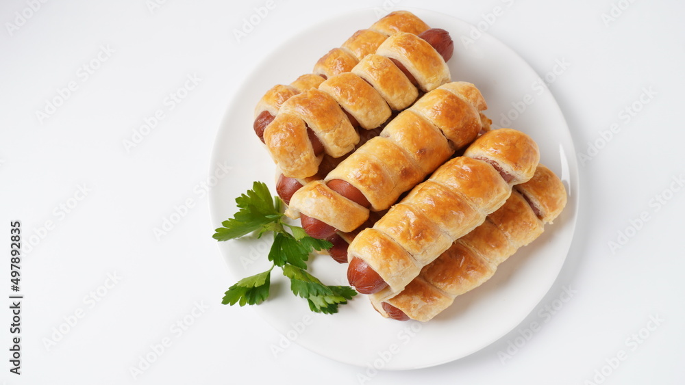 Sausage buns. Soft baked bun (dough )stuffed with sausage for fast food breakfast or coffee break. Sausage roll, (hot dog). Sausage buns. Soft baked bun (dough )stuffed with sausage for fast food breakfast or coffee break. Sausage roll, (hot dog).