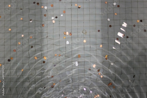 ripples in a water fountain with coins photo