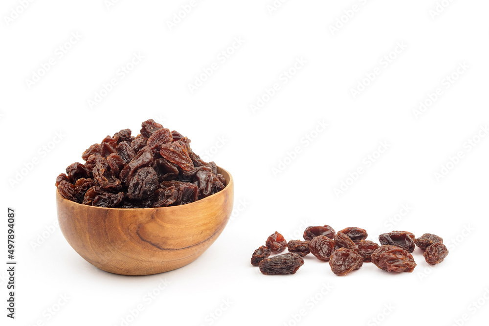 Organic dried Raisins in wooden bowls on white background, Currant Organic dried Raisins in wooden bowls on white background, Currant