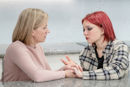Careful mother talks with her teen daughter about her problems. Teenagers problem concept