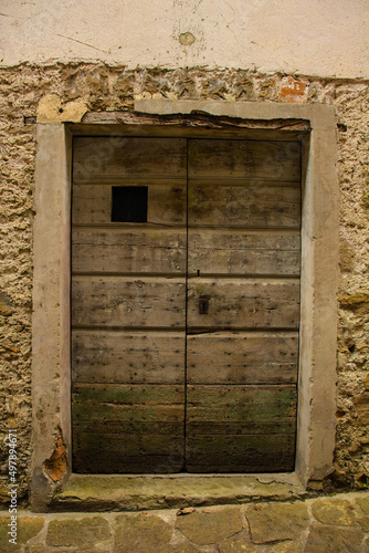 An old wooden door in Poffabro, an historic medieval village in the Val Colvera valley in Pordenone province, Friuli-Venezia Giulia, north east Italy
 photo