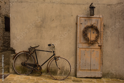 An old wooden door and bike in Poffabro, an historic medieval village in the Val Colvera valley in Pordenone province, Friuli-Venezia Giulia, north east Italy
 photo