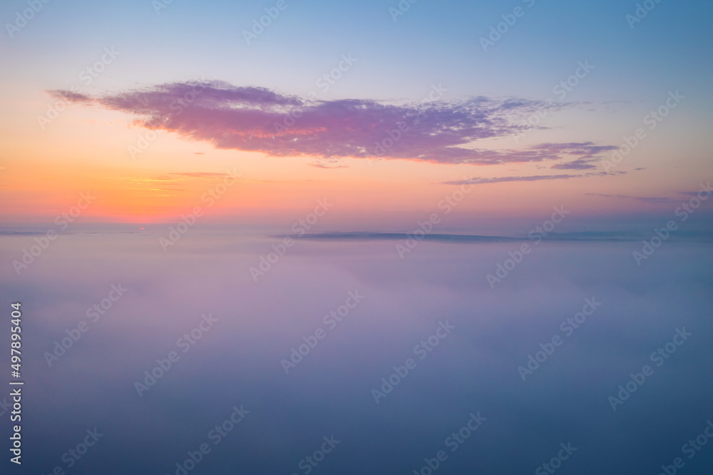 Bird's eye view of the fantastic ocean of clouds at sunrise. Aerial photography, drone shot.