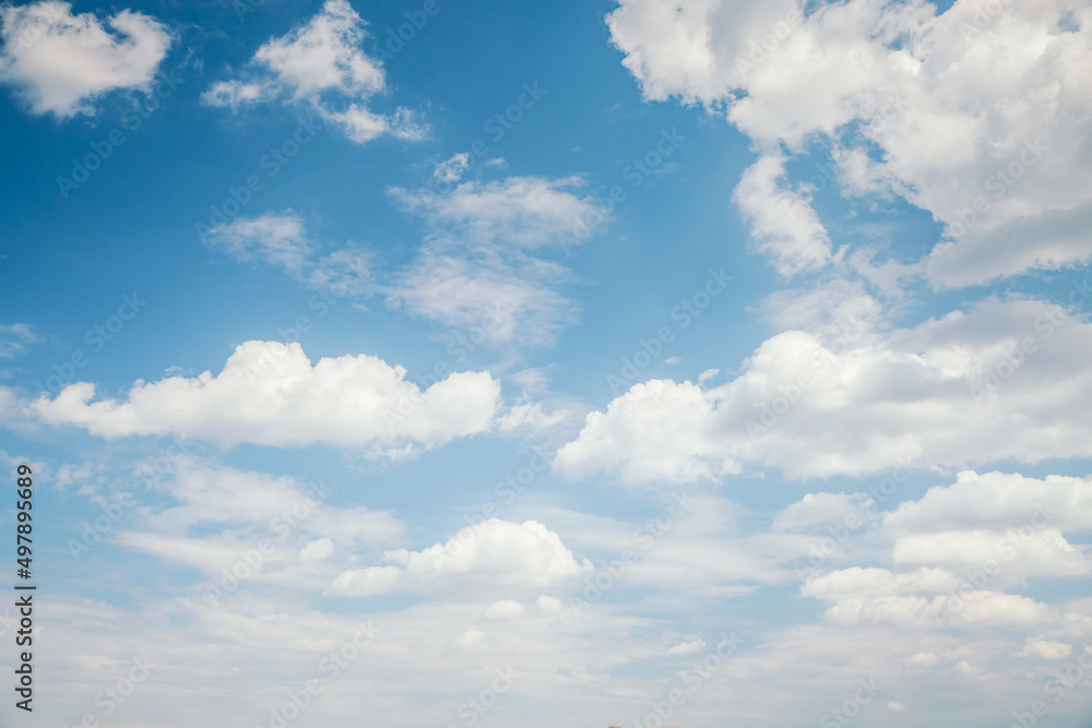 Blue sky background with white fluffy clouds in the fresh sunny day. Blue sky background with white fluffy clouds in the fresh sunny day.