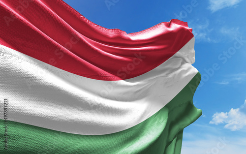 Obraz na plátně Hungarian Flag is Waving Against Blue Sky with Clouds