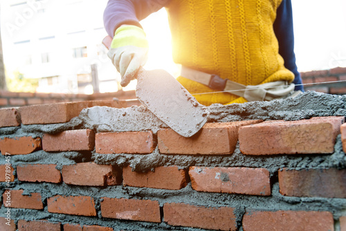 Close up of bricklayer building walls