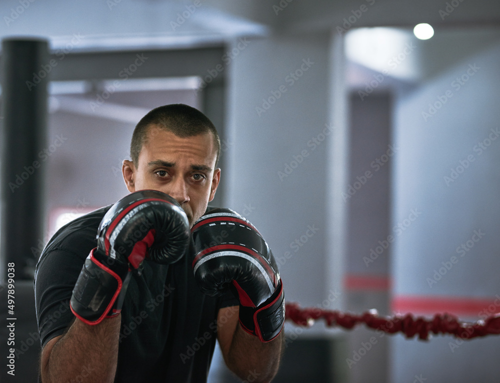 Boxing Rin Training Working on his form. Cropped portrait of a young male athlete training ...