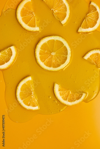Top view of fresh slice lemons juice and gel serum, organic cosmetics, vitamin C, fresh citrus fruits, Lemon extract, flat lay, copy space.