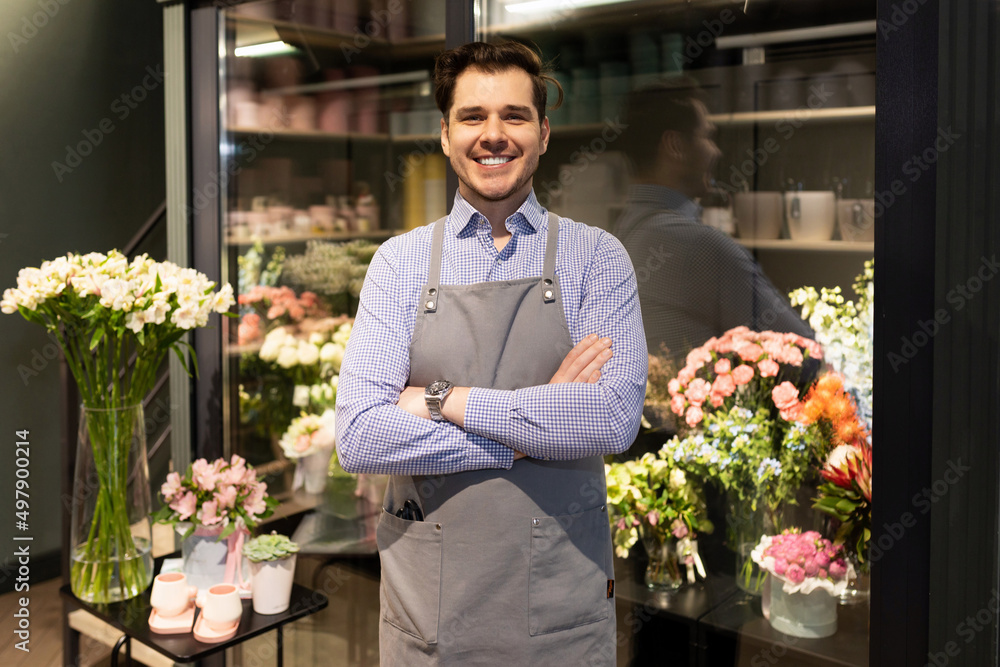 flower shop employee on the background of the refrigerator with fresh bouquets
