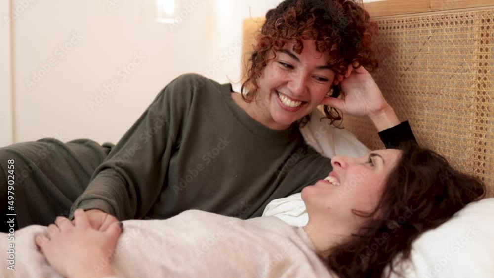 Gay pregnant female couple having fun in bed at home - LGBT lesbian surrogate concept Gay pregnant female couple having fun in bed at home - LGBT lesbian surrogate concept