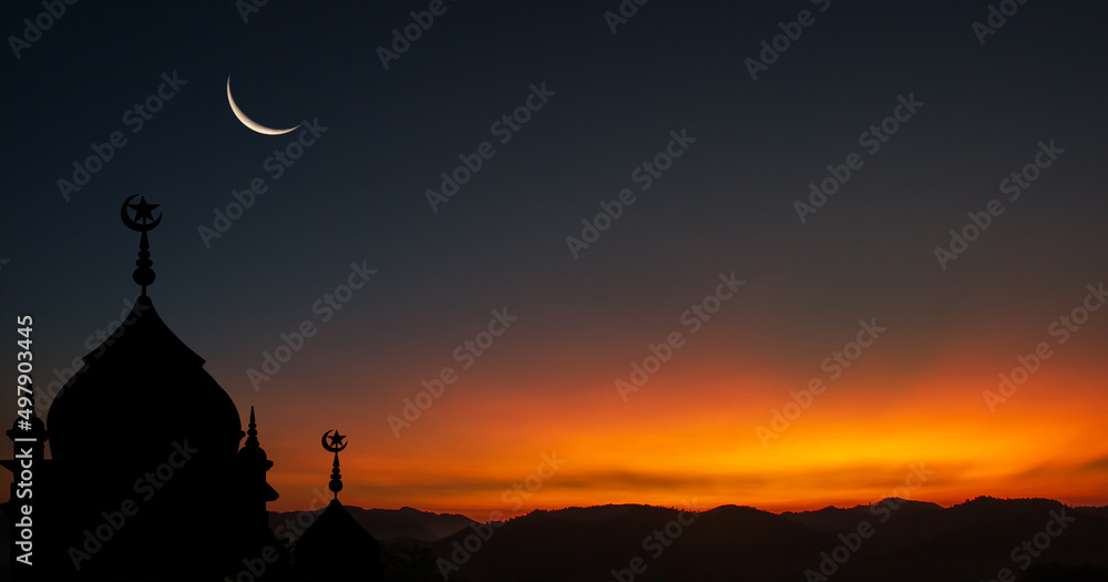 silhouette of a mosque at sunset with crescent moon on dusk sky in the evening religion of Islamic in ramadan month, Eid Al Adha, Eid Al Fitr
