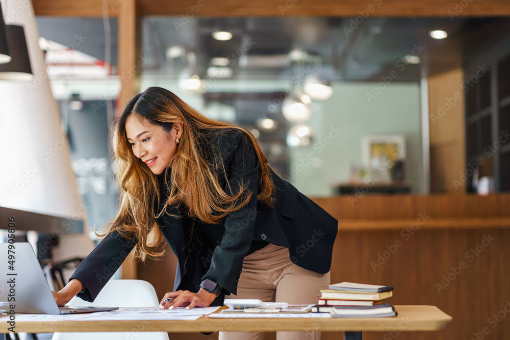 Attractive brunette Asian businesswoman using laptop computer, exciting and celebrating with good news. Attractive brunette Asian businesswoman using laptop computer, exciting and celebrating with good news.