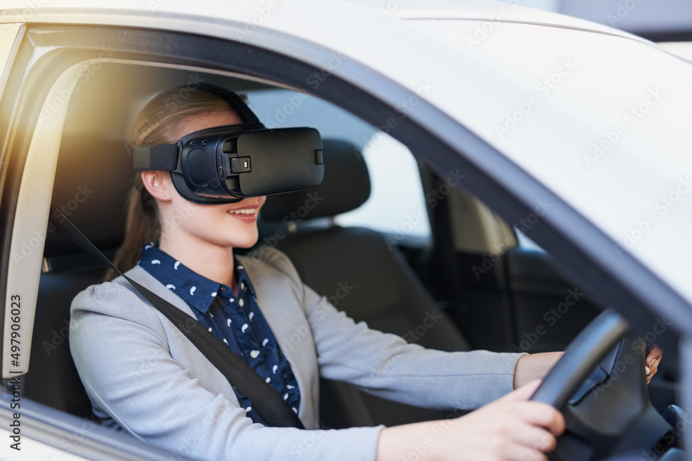 Test driving a new car with virtual reality. Cropped shot of a young businesswoman driving while wearing a virtual reality headset.