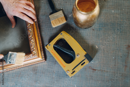 Framing Workshop. Painting baguette handmade picture frame at studio. photo