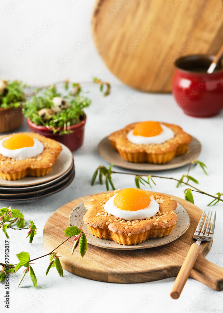 Fresh baked sweet flower shaped cakes with apricot, icing and chopped almond nuts. Homemade Easter food concept. Copy space. Fresh baked sweet flower shaped cakes with apricot, icing and chopped almond nuts. Homemade Easter food concept. Copy space.