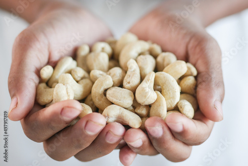 cashew nut on palm of hand close up 