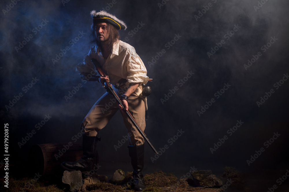 Pirate filibuster sea robber in suit with gun and saber. Concept photo Pirate filibuster sea robber in suit with gun and saber. Concept photo