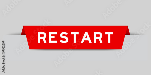 Red color inserted label with word restart on gray background