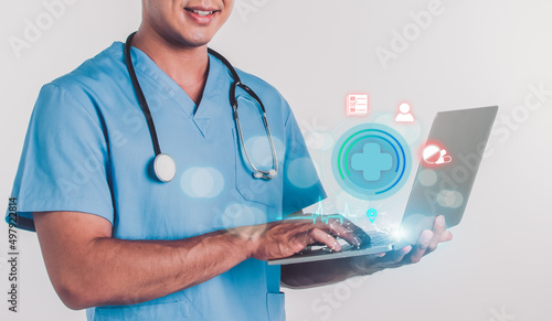 Doctor with stethoscope, holding and using laptop for telemedicine service, showing global network connection technology, giving online treatment consultation to patients. Medical Concept. photo