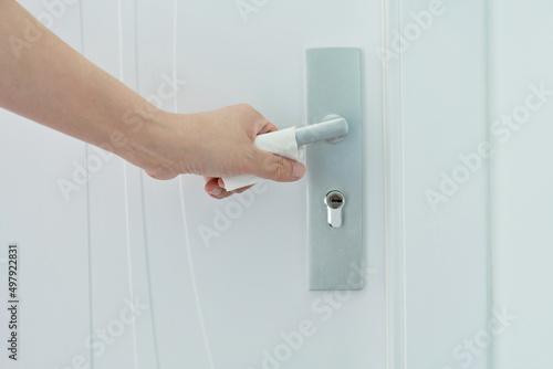 Woman's hand open the door with napkin