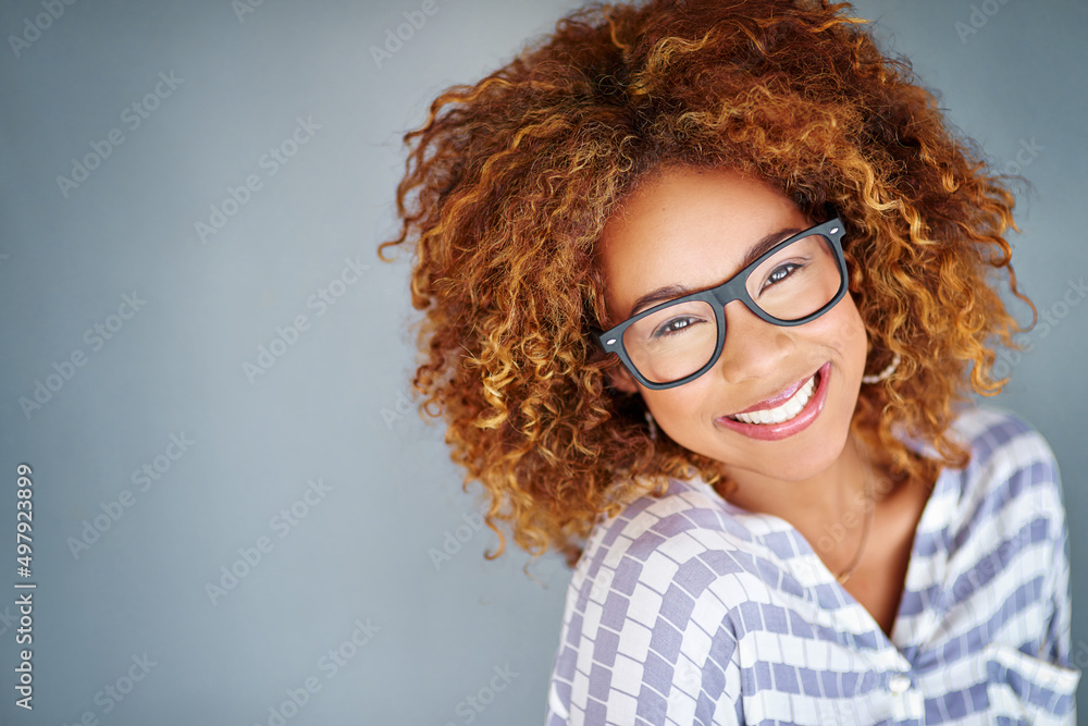 Full of self confidence. Studio shot of a young businesswoman against a gray background. Full of self confidence. Studio shot of a young businesswoman against a gray background.