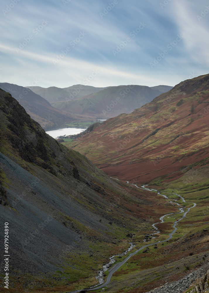 Stunning colorful landscape image of view down Honister Pass to Buttermere from Dale Head in Lake District during Autumn sunset
