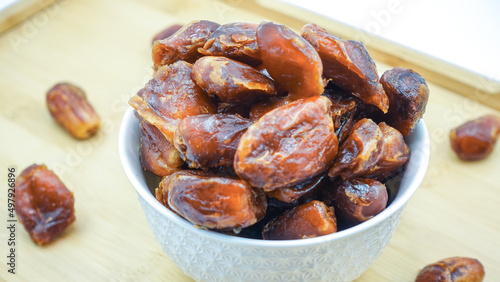 Dates also known as Khajur. Tasty dry dates isolated on white background. Arabic food that muslims eat during Ramadan. Super dietery food. 