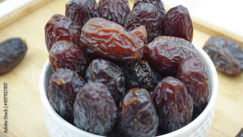 Dates also known as Khajur. Tasty dry dates isolated on white background. Arabic food that muslims eat during Ramadan. Super dietery food.  photo