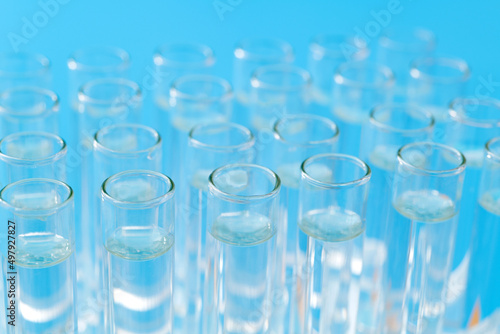 Test tubes with liquid on blue background