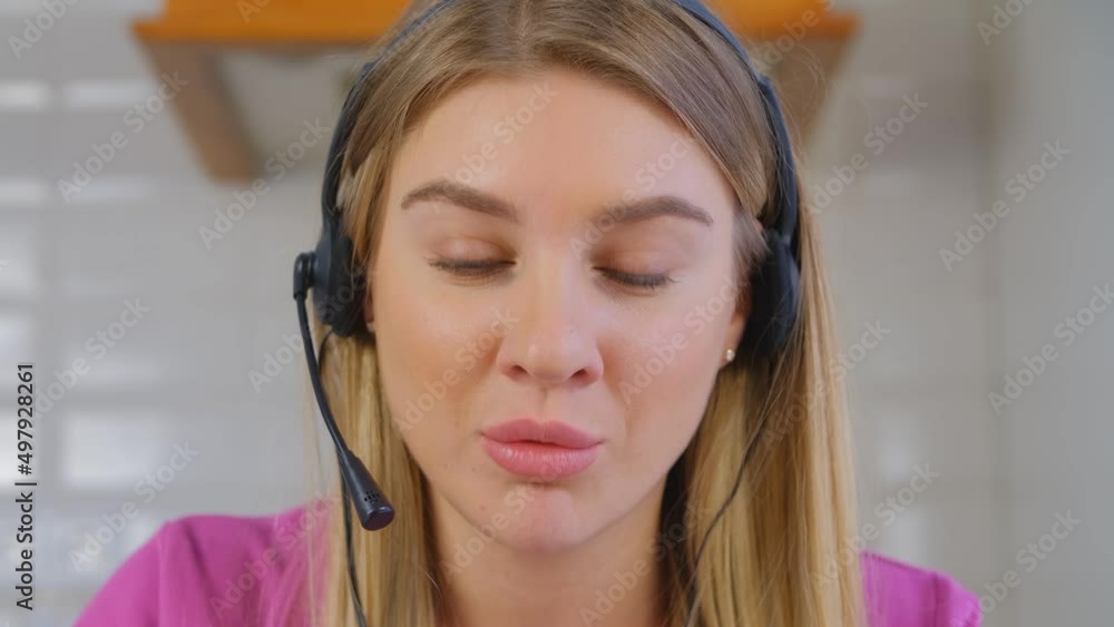 Call center operator in headset. Friendly online support assistant talking to a client on a phone call Call center operator in headset. Friendly online support assistant talking to a client on a phone call