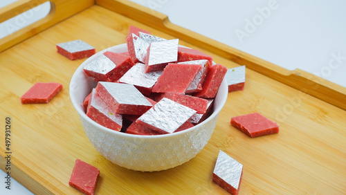 Kaju Katli is a traditional Indian Diamond shaped sweet or Mithai made using cashew paste, sugar, and mava or Khoya. Almond Sweet burfi or barfee. Popular festive food and sweet from India. photo