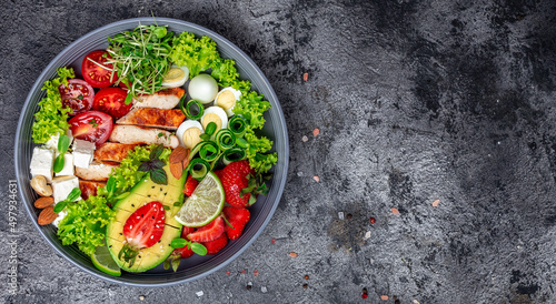 Obraz na plátně Ketogenic diet food, chicken fillet, quinoa, avocado, avocado, feta cheese, quail eggs, strawberries, nuts and lettuce