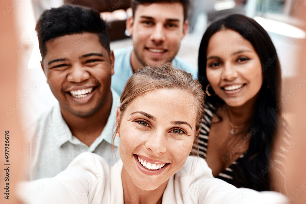 Theres success behind those smiles. Cropped portrait of a group of young business colleagues taking selfies in their office. Theres success behind those smiles. Cropped portrait of a group of young business colleagues taking selfies in their office.