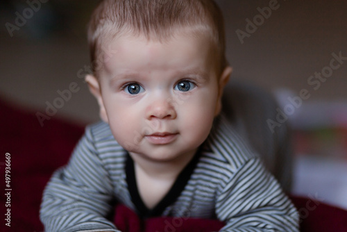 Portrait Of white Baby Toddler Smiling Sitting On Bed Indoor