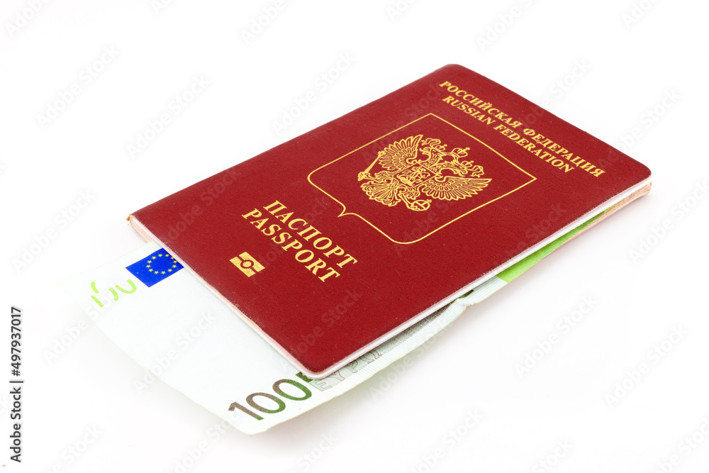 Russian passport with 100 euro banknote isolated on white background. Concept of currency restrictions for Russia, bribe or purchase of citizenship. Russian passport for travelling abroad Russian passport with 100 euro banknote isolated on white background. Concept of currency restrictions for Russia, bribe or purchase of citizenship. Russian passport for travelling abroad