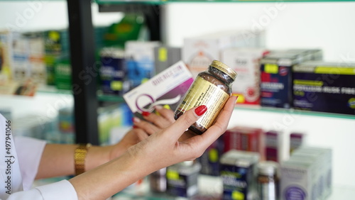Woman Shopping for Capsule Medicine in Pharmacy