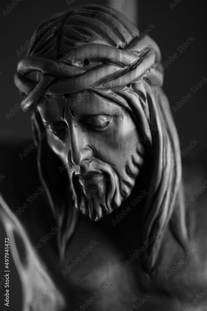 Religion theme - Jesus Christ. Cruciefied Jesus figure isolated on rustic dark background.