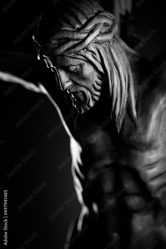 Religion theme - Jesus Christ. Cruciefied Jesus figure isolated on rustic dark background. Religion theme - Jesus Christ. Cruciefied Jesus figure isolated on rustic dark background.