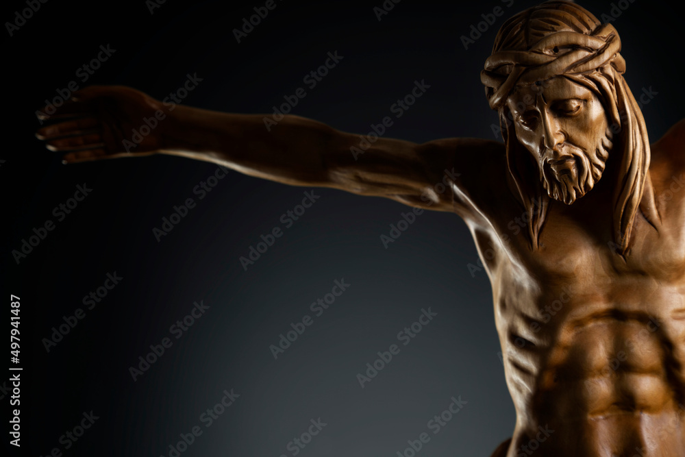 Religion theme - Jesus Christ. Cruciefied Jesus figure isolated on rustic dark background. Religion theme - Jesus Christ. Cruciefied Jesus figure isolated on rustic dark background.