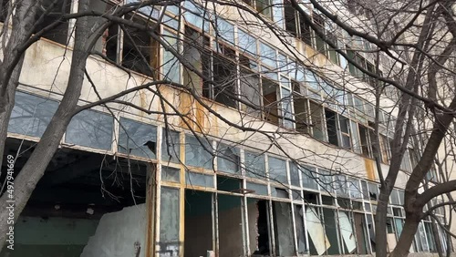 Abandoned concrete industrial building with broken windows. Old factory for demolition