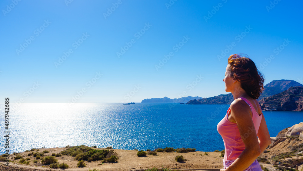 Woman enjoy sea breeze.