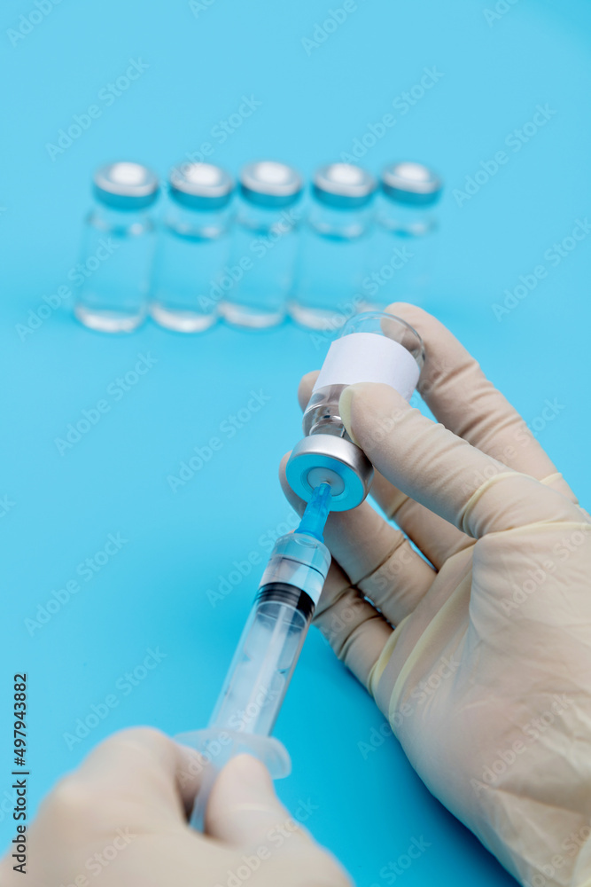 Hand holding syringe and vaccine Hand holding syringe and vaccine