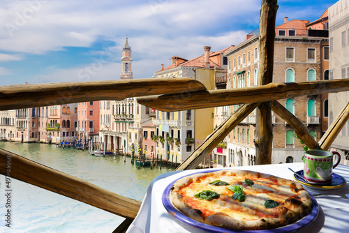 Italian pizza Margarita served on terrace overlooking to Venetian canal, Venice, Italy © elvirkin