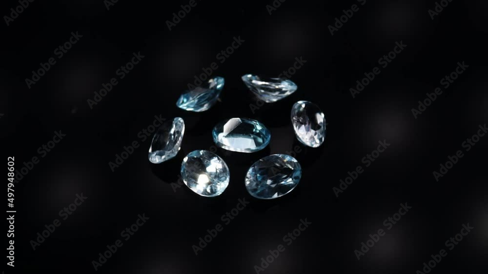 natural blue topaz gemstones on the dark background turning table natural blue topaz gemstones on the dark background turning table