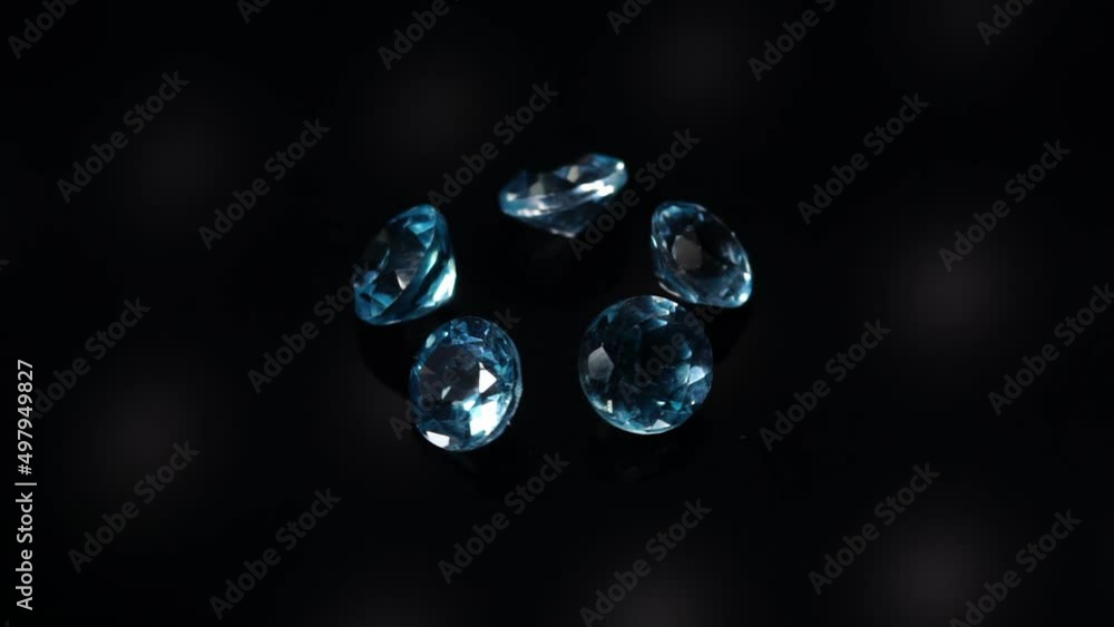 natural blue topaz gemstones on the dark background turning table natural blue topaz gemstones on the dark background turning table