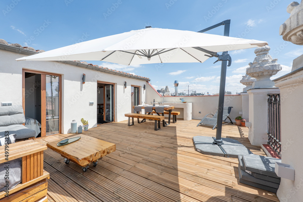 Terrace with a large parasol awning with wooden floors, dining table with wooden benches and solid wood - obrazy, fototapety, plakaty 