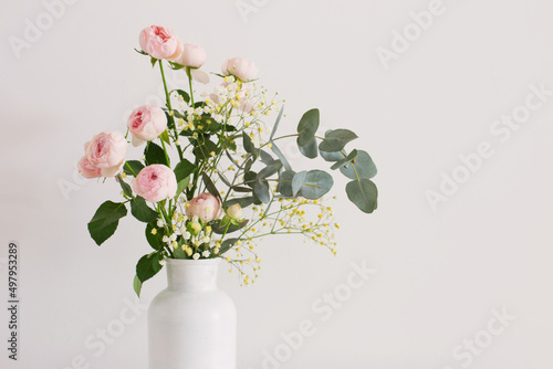 bouquet of pink roses in ceramic white vase  on white background