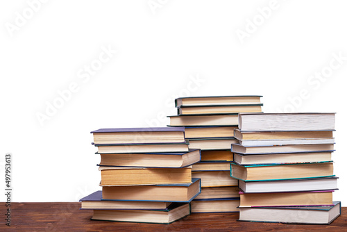 Three stacks of books on a wooden table  isolated on a white background.