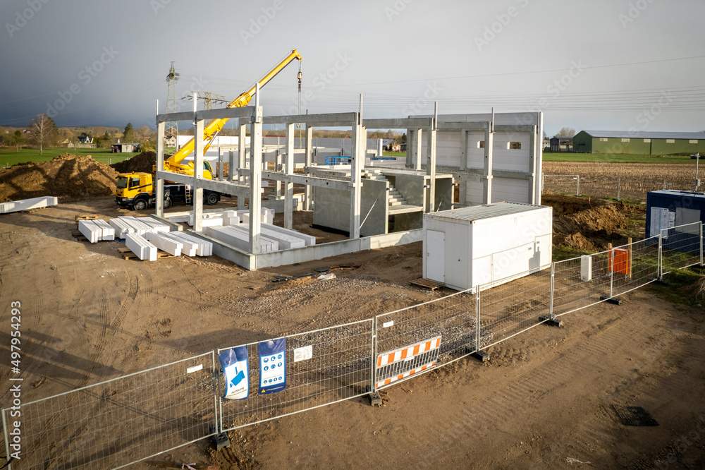 Fototapeta premium the basic structure of an industrial building is erected on a construction site