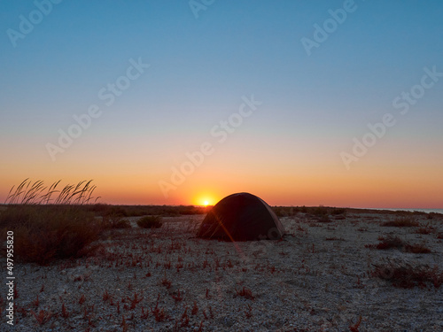 Camping on a beach at sunrise on Tendra Spit, Kherson Oblast, Ukraine.